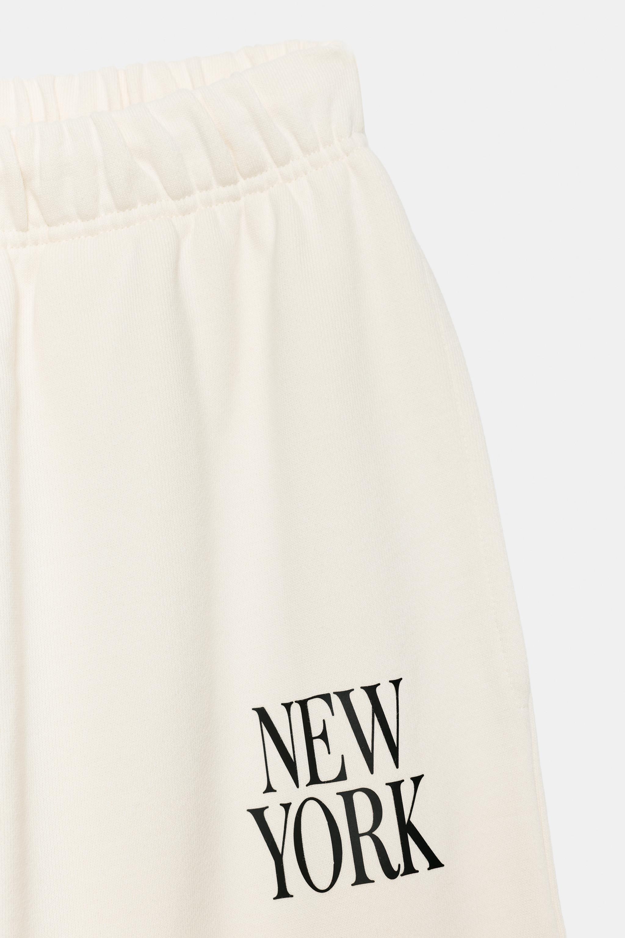 TEXT WIDE-LEG TROUSERS